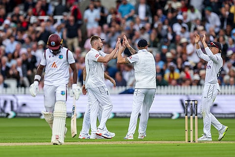 Gus Atkinson and Zak Crawley celebrate wicket of Kirk Mckenzie